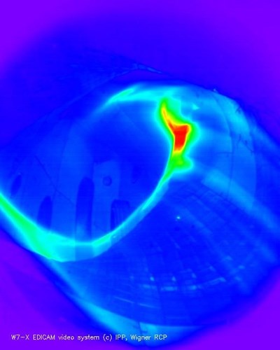 A plasma discharge in the upgraded Wendelstein 7-X stellarator — not your usual D-shaped tokamak plasma... Photo: IPP/Wigner RCP (coloured black-and-white photo) (Click to view larger version...)