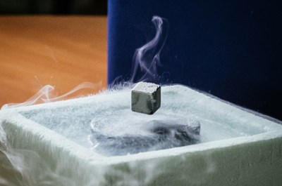 At extremely low temperatures, materials enter the superconducting state. Their magnetic field is thrust outside the material and causes the magnet to levitate. © CERN (Click to view larger version...)