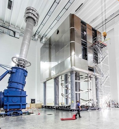 A powerhouse on stilts—like its real-scale mockup at the MITICA test facility in Padua, Italy, the high-voltage deck and its giant bushing will stand in an otherwise empty hall in order to avoid the generation of electrical arcs. (Click to view larger version...)