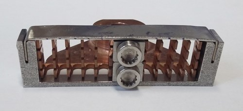 The final prototype clamp, complete with battle scars from testing. Over 12,000 clamps will be installed inside the vessel, positioned at intervals of around 60 mm along each cable. (Click to view larger version...)