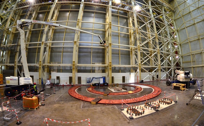 The red base plates have been mechanically installed; next, contractors will add grouting and install the first rail components. Space is reserved on the right for a second sector sub-assembly tool (SSAT #2), whose elements are under construction now in Korea. (Click to view larger version...)