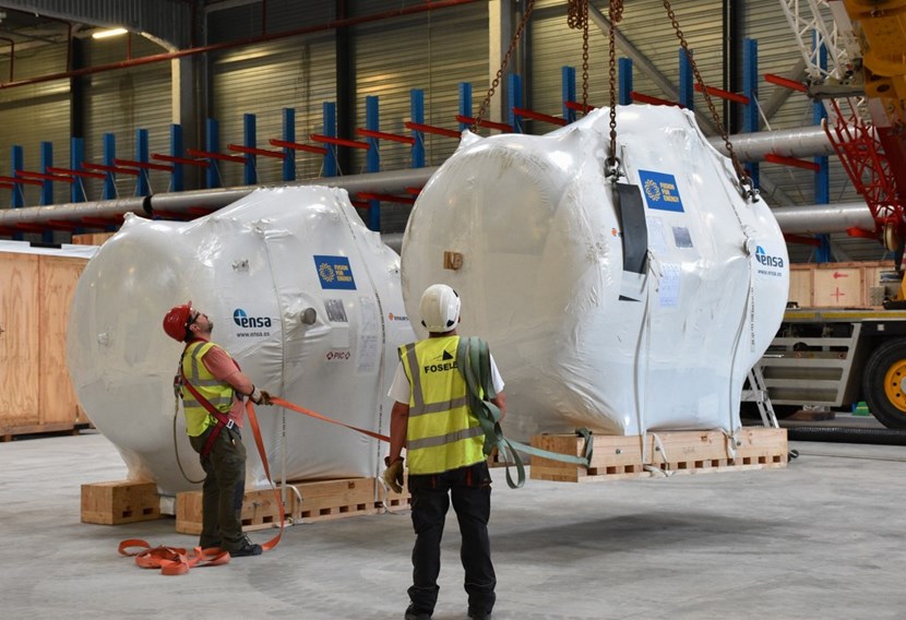 Two small holding tanks that are part of the water detritiation system are stored in a warehouse awaiting installation in the Tritium Building. (Click to view larger version...)