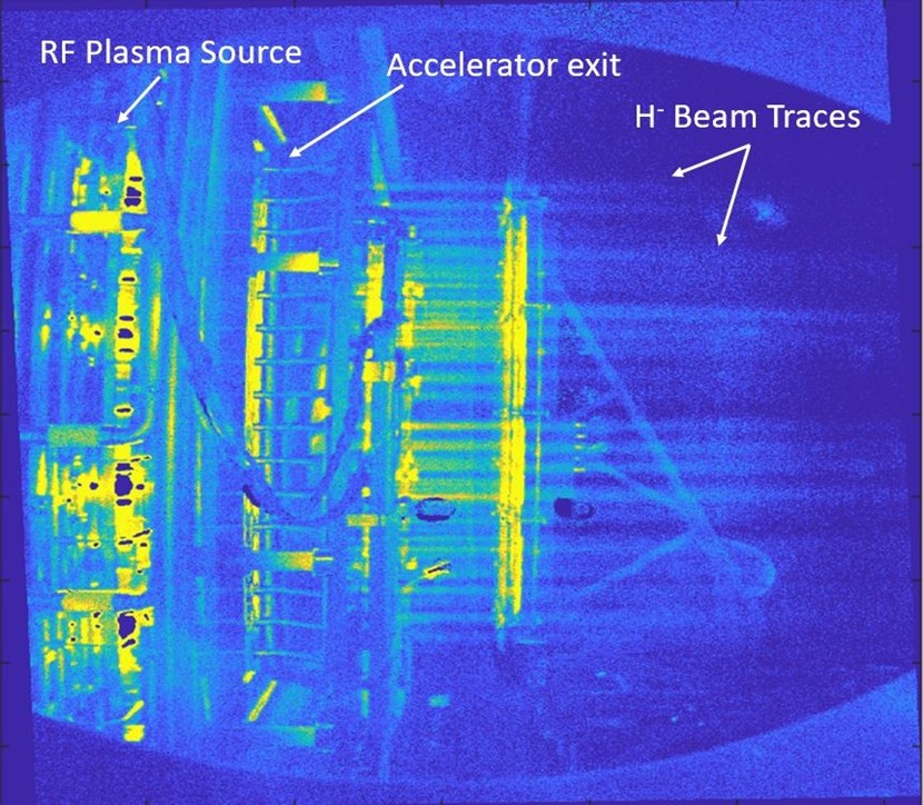 The light emitted when the accelerated particles interact with the background gas inside the vacuum vessel allows the visualization of the SPIDER beam (travelling from left to right in the figure). (Click to view larger version...)