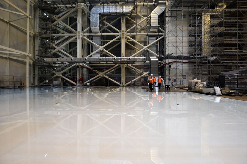 Pouring and spreading 24 tonnes of epoxy resin over a 6,500-square-metre surface—bucket after bucket. (Click to view larger version...)