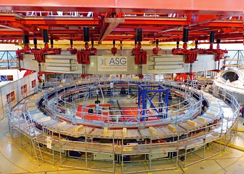 The 280-tonne winding pack for poloidal field coil #5 (PF5) is lifted from the impregnation station and transferred to the final assembly station in an all-day operation. Special clamps and lifting accessories were developed so that the coil could be handled with the utmost of care. (Click to view larger version...)