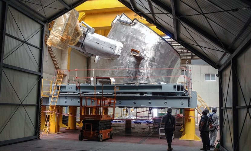 Before leaving the Hyundai Heavy Industries factory in Ulsan, Korea, the 440-tonne sector was wrapped and inserted into protective casing. Sector #6 is seen on its side in this photo with one of its two port stub extensions visible. (Click to view larger version...)