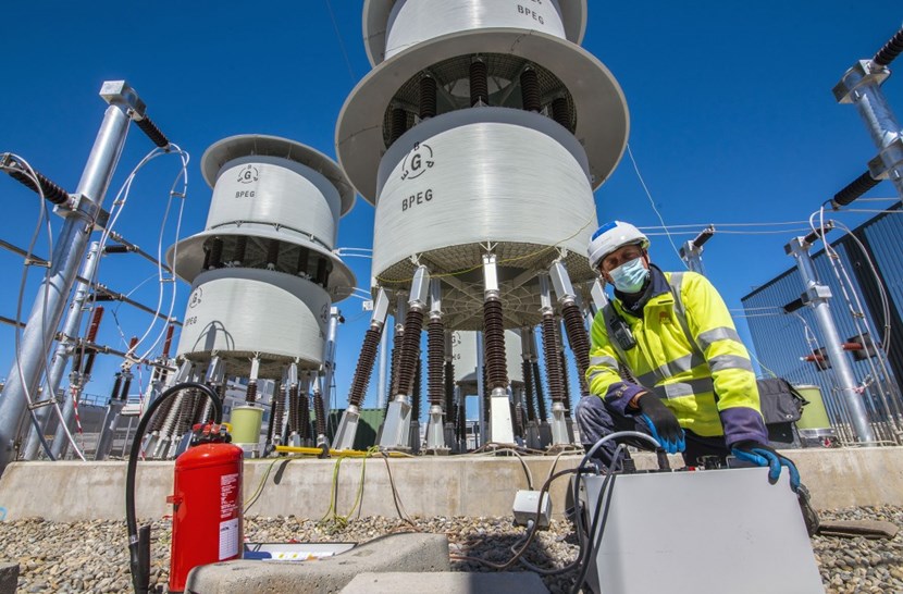 Protected by fire-resistant work wear, headpiece and face shield, ITER electrical engineer Massimiliano Camuri proceeds to the testing of one of the 8-metre-tall thyristor-controlled reactors. (Click to view larger version...)