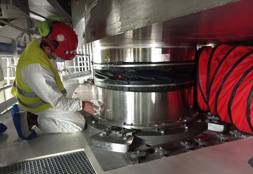 Preservation is particularly critical for ''captive'' components that may need preserving for a decade or longer before entering service. Here, a worker performs a white cloth test to check for moisture on a cryostat support bearing during a preservation inspection. (Click to view larger version...)