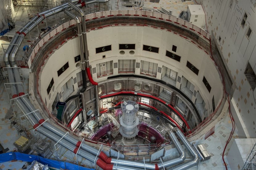 The port cells are numbered at the top of the assembly pit (photo). Once all nine vacuum vessel sub-assemblies are in place, the central column will be removed. In its place, operators will install the central solenoid. (Click to view larger version...)