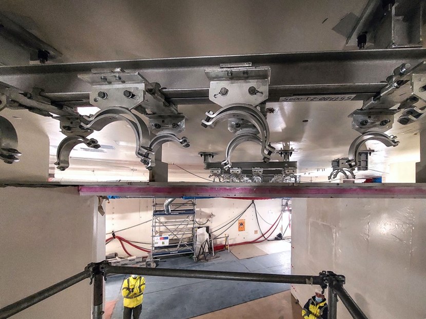 Recently installed supports at the L1 level of the Tokamak Building, showing some of the detail of how the supports are bolted to the ceiling by first welding threaded studs to steel plates embedded in the ceiling concrete. This allows for high accuracy in the installation of the optical beamlines. (Click to view larger version...)