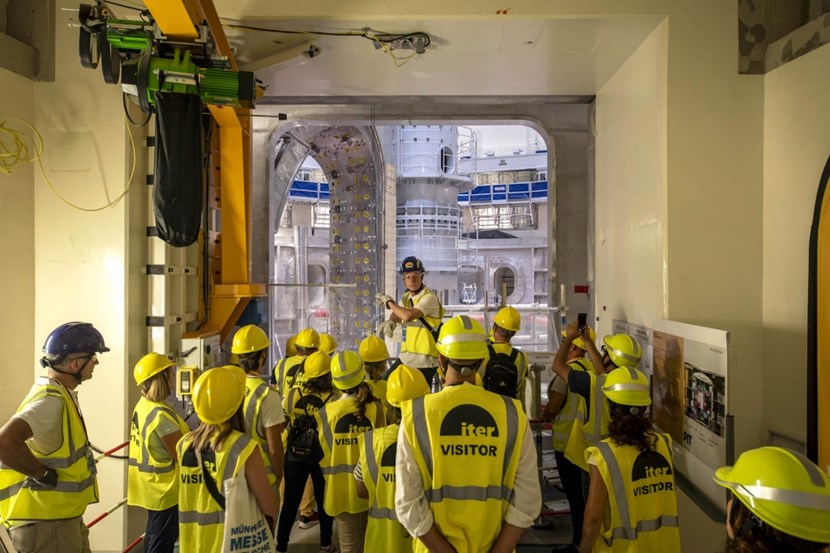 Looking into the Holy of Holies: Jens Reich, Head of the ITER Ex-Vessel Delivery & Assembly Division, provides explanations on the ''sector module'' that was installed one year ago in the Tokamak assembly pit. (Click to view larger version...)