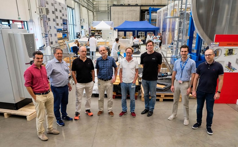 Engineers and physicists from the Neutral Beam Injection Group at the Max Planck Institute for Plasma Physics together with members of the Neutral Beam Test Facility Team in the experimental hall. (Click to view larger version...)
