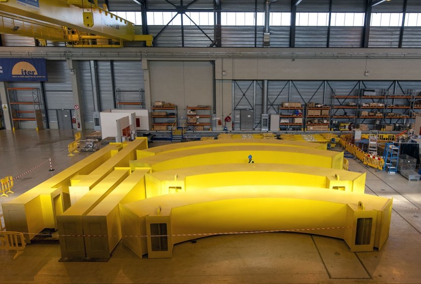 Segments of the dismantled circular spreader beam, weighing up to 6 tonnes, rest on the floor of the European Poloidal Field Coils Winding Facility. (Click to view larger version...)