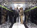 The CEA-F4E CSC team standing between a section of the Helios supercomputer, from left to right: Jacques David, François Robin, Jacques Noé (CEA) and Susana Clement Lorenzo (F4E).