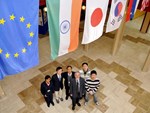 The second group of Monaco Fellows stands below the ITER Member flags with David Campbell, head of the Plasma Operation Directorate. 