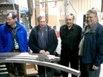 In front of the central solenoid conductor jacket bending trials, from left to right: Chris Rey (US-DA), Paul Libeyre (ITER), Charles Lyraud (ITER) and Wayne Reiersen (US-DA).