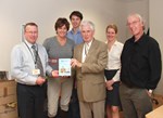 Mike Forrest handing over a copy of his book to the ITER Newsline team.
